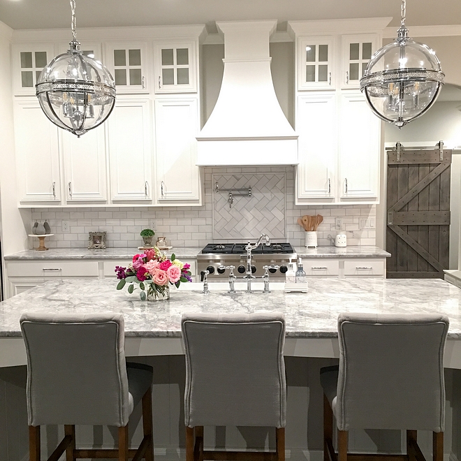 White Farmhouse Kitchen White Farmhouse Kitchen with Superwhite quartzite countertop and clear glass globe chandeliers White Farmhouse Kitchen