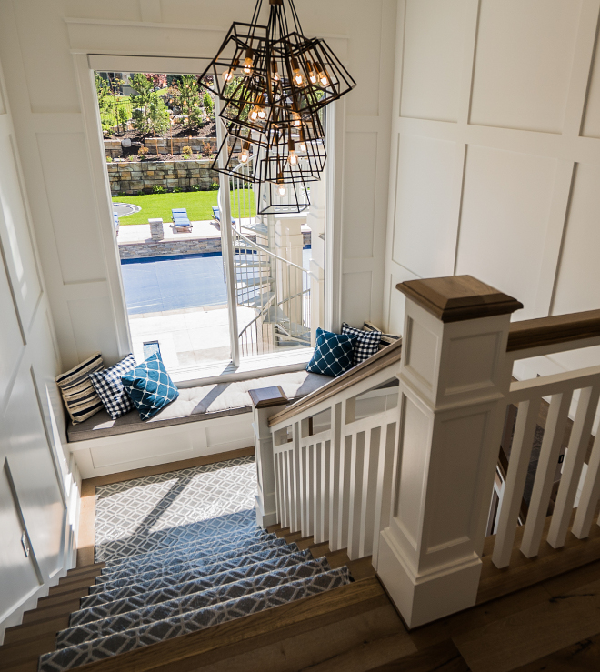 Staircase with Industrial Lighting window seat and grid board and batten paneling Paint Color Super White Benjamin Moore