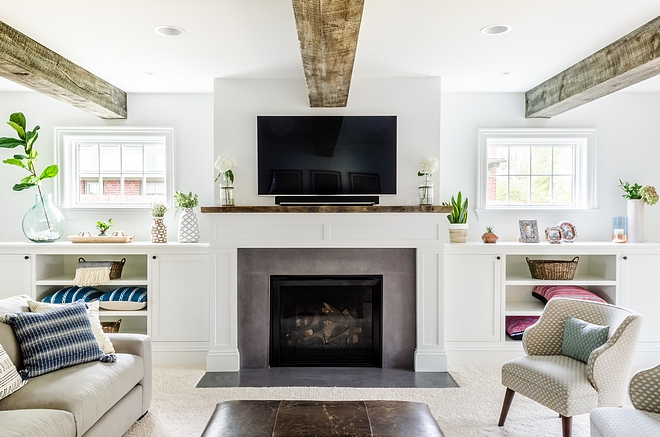 Farmily room with reclaimed beams and grey fireplace Grey fireplace surrournd Grey quartz fireplace