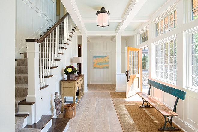 Cottage Foyer lakehouse cottage foyer with White Oak Hardwood Floors, beadboard paneling and Marvin doug fir wood windows with Waterglass obscure glazing doors and windows