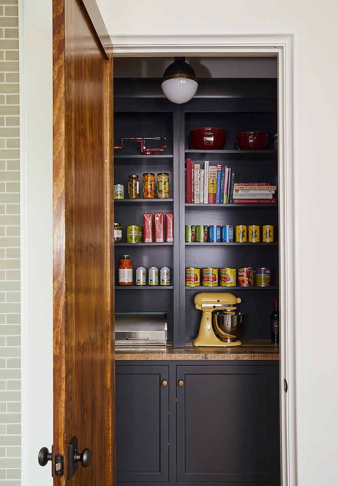 Pantry Walk in pantry with navy blue back cabinets and open shelves painted in a Benjamin Moore paint color sources on Home Bunch #pantry #walkinpantry #BenjaminMoore #paintcolor