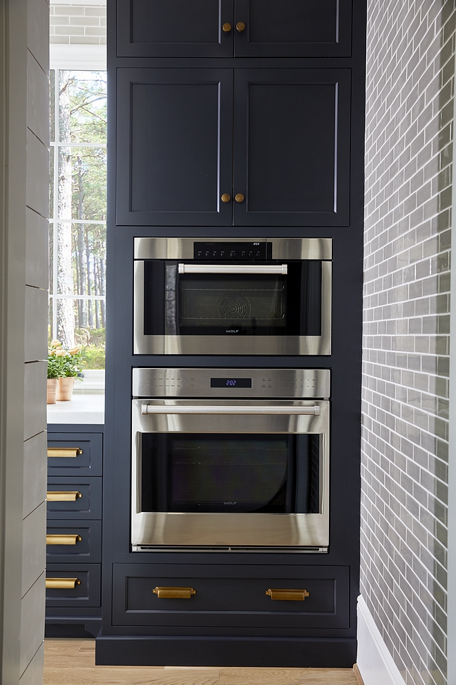 Midnight Oil by Benjamin Moore A pantry with its own farmhouse sink and built-in ovens is located behind the range wall Paint Color is Midnight Oil by Benjamin Moore #BenjaminMoore #pantry
