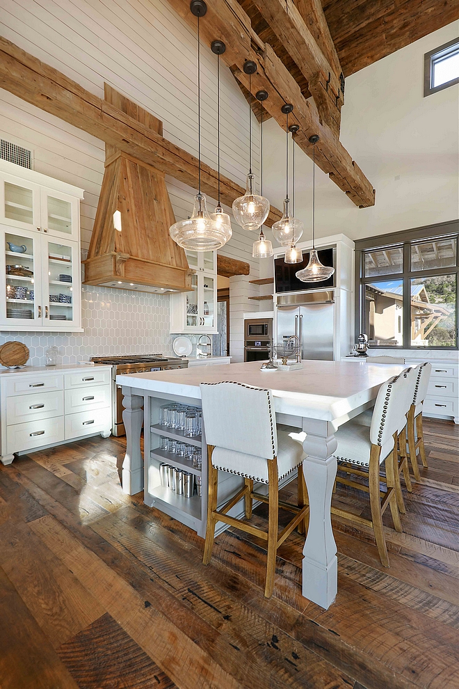 Grey Walker Zanger backsplash tile is blended with reclaimed materials in this rustic farmhouse kitchen elongated hex tile