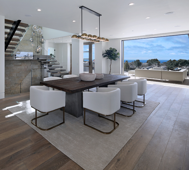 Modern dining room This sleek dining room features an open and airy feel. Chandelier is custom #moderndiningroom #diningroom