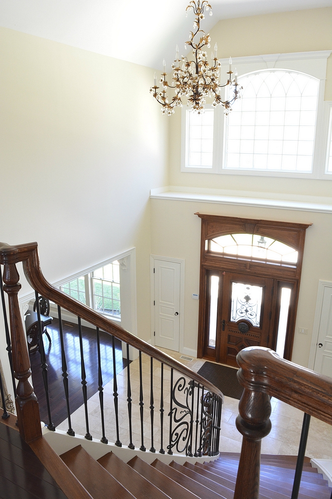 Hanging from the 25 foot high ceilings is the foyer’s chandelier It’s comprised of gold leaves and crystal flowers It actually has a motor up top which allows us to lower the chandelier for cleaning with an easy flick of the switch