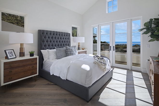 Inviting bedroom with grey tufted bed and mid-century inspired dressers