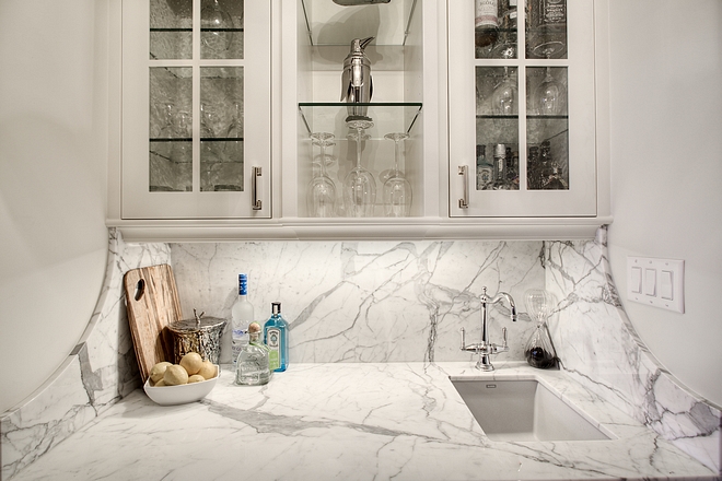 Curved Marble Backsplash The butlers pantry features solid Statuario slab marble countertop and backsplash with a curved return #butlerspantry #curvedmarblebacksplash #marble