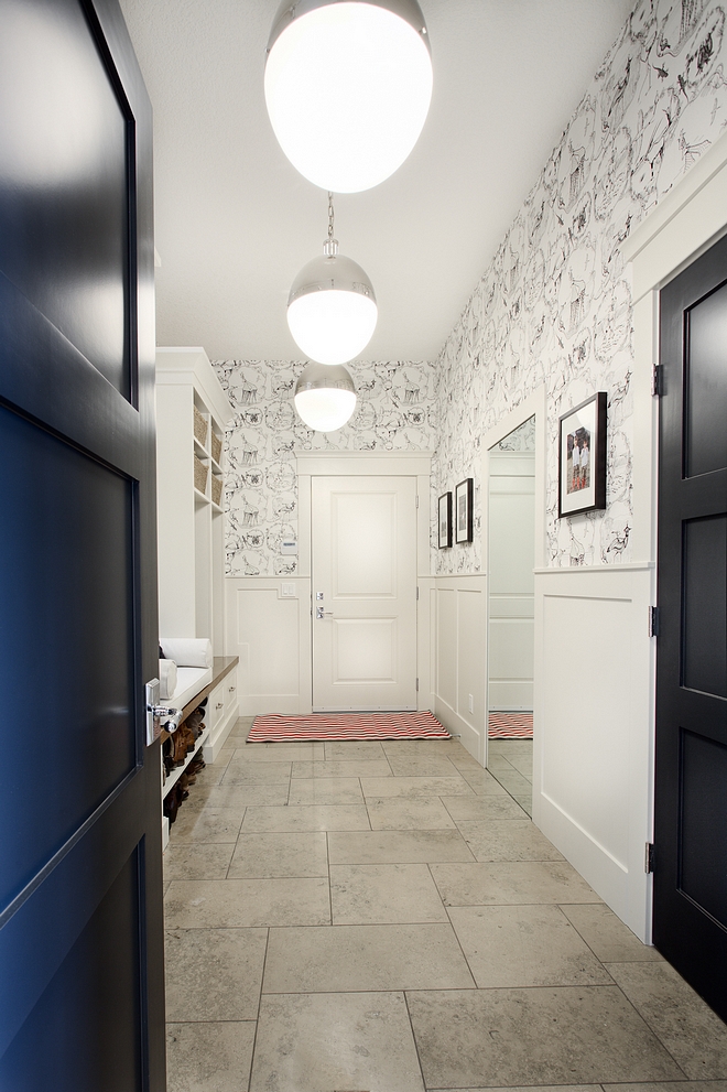 Mudroom Mudroom Ideas Mudroom features limestone floor laid in hop scotch pattern oversized globe pendants wainscoting and wallpaper above wainscoting #mudrrom