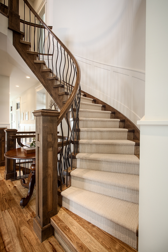 Staircase is open stringer closed risers with Hickory tread caps and wool carpet inlay