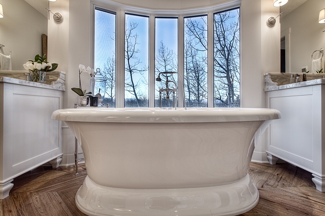 French bathroom with freestanding bath by floor to ceiling windows all sources on Home Bunch #Frenchbathroom #freestandingbath #bathroomwindows