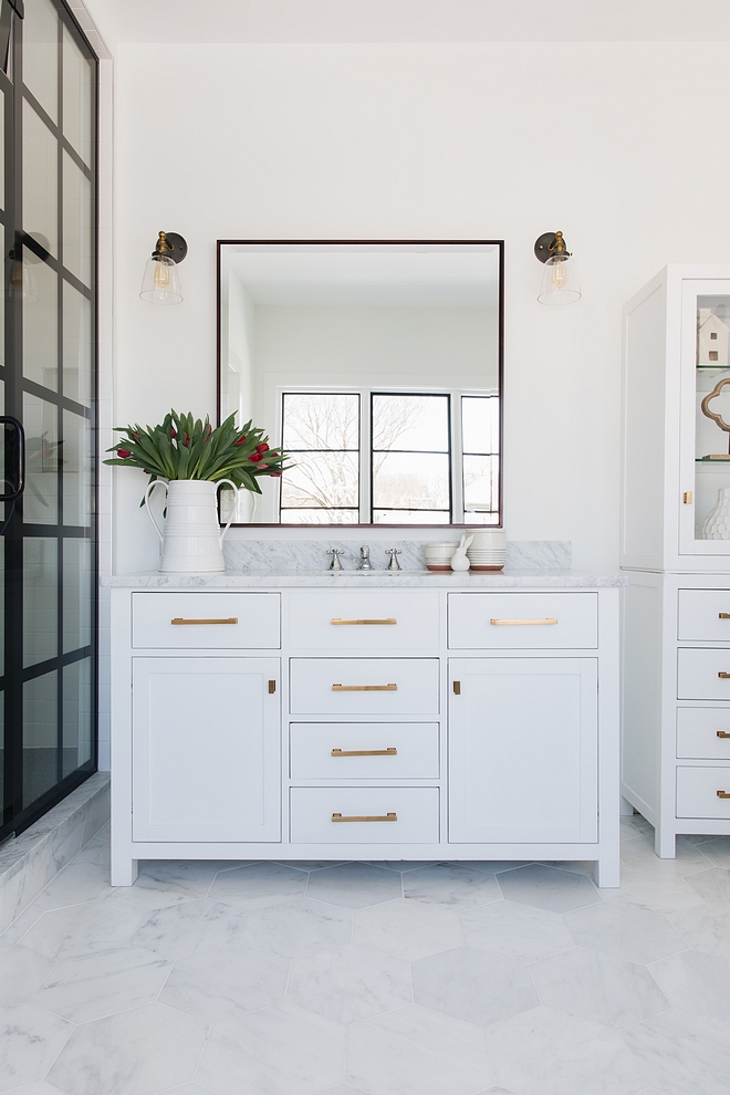 Modern Farmhouse bathroom with steel shower white vanity with brass pulls and oversized hex tile Modern farmhouse bathroom black steel shower #ModernFarmhousebathroom #ModernFarmhouse #bathroom #steelshower #whitevanity #brasspulls #oversizedhextile #hextile