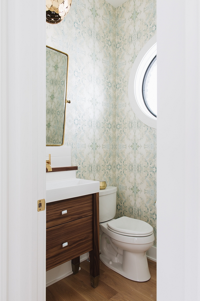 Powder Room The main floor powder room is beautiful and welcoming featuring a mint and metallic gold wallpaper Vanity is Walnut #powderroom #wallpaper #walnutvanity