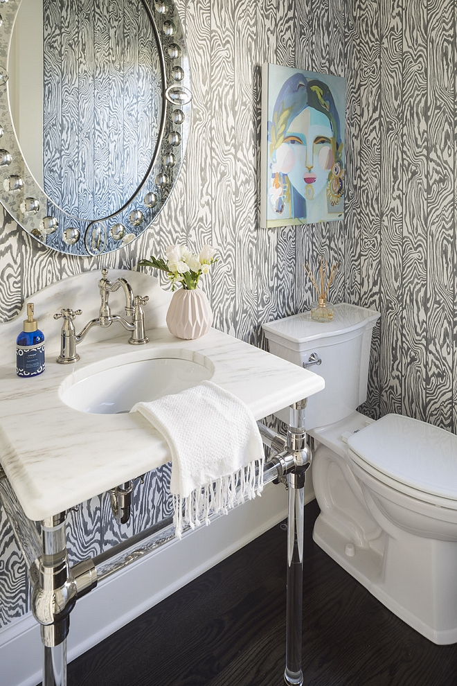 Cole and Son Black and White Zebrawood Wallpaper powder bathroom features Cole and Son Black and White Zebrawood wallpaper and a washstand with white marble countertop and acrylic base #ColeandSon #BlackandWhite #Zebrawood #Wallpaper
