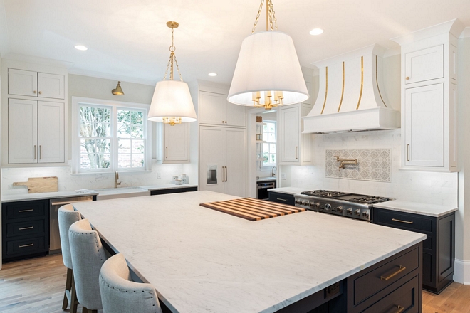 Honed white marble kitchen island with built in butcher block The Carrera Marble tops were hand picked from a local slab yard after countless hours searching for the perfect ones #carreramarble #countertop #slab
