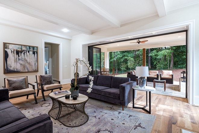 Indoor/Outdoor living at it's finest with these jaw dropping panoramic doors leading out the the covered blue stone terrace for added living space