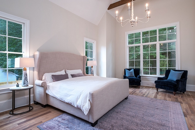 Modern Farmhouse Master Bedroom Windows gets lots of natural light and the 17 foot vaulted ceilings with rough sawn beams add dimension and make the space feel even larger than it is #modernfarmhouse #farmhosuebedroom #windows #beams