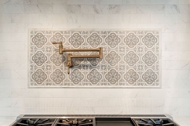 Kitchen backsplash above range Kitchen tile above stove Backsplash is Honed Carrera Marble tile with custom picture frame detail #backsplash