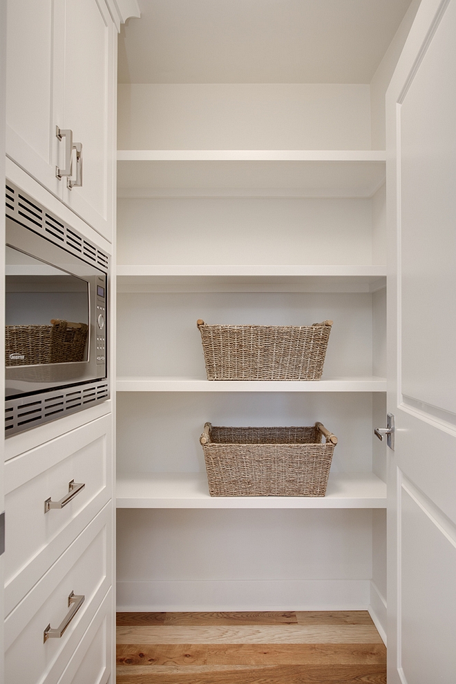 Pantry Kitchen Pantry paint color Benjamin Moore White Dove Pantry Kitchen Pantry Pantry features a combination of built-in cabinets with a built-in microwave and open shelves #pantry #pantrypaintcolor #openshelves #builtincabinet #pantrycabinet