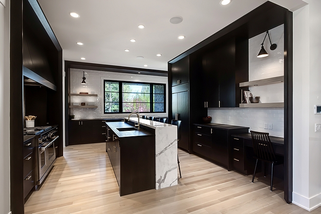 Kitchen with Black cabinets Black kitchen Black and white kitchen This kitchen feels dramatic, modern and unapologetic I love the layout and the raised kitchen island The designer/builder went with a 1/4 sawn white oak for all of the back stained cabinetry #blackkitchen #kitchenlayout #kitchencabinet #blackkitchencabinet #blackcabinet