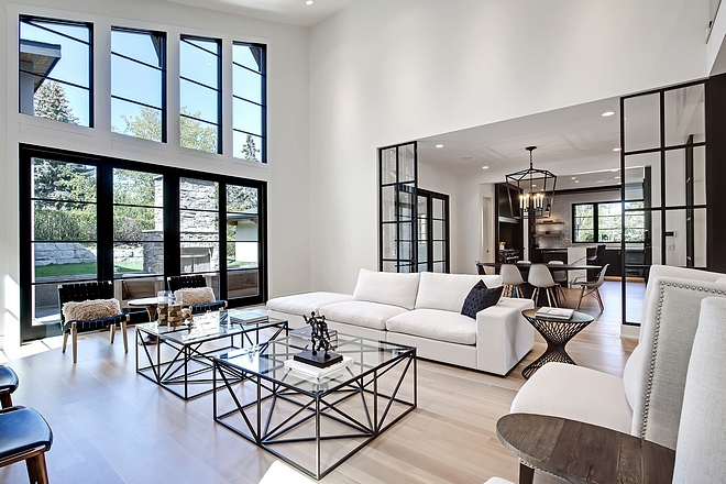 This bright Great Room features 8’ tall black sliding patio doors and high vaulted ceiling #GreatRoom #Blackpatiodoor #blackwindows #highceiling #vaultedceiling