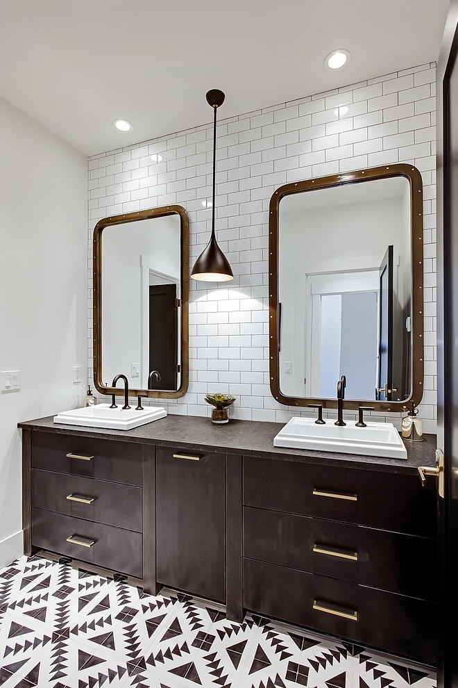 Bathroom bathroom bathroom features heated 8” x 8” black and white cement tiles custom vanity, subway tile from counter to ceiling and a pair of industrial mirrors #bathroom