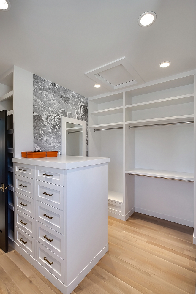 Walk in closet This oversized walk-in closet has extensive shelving, shoe area, seating bench, full length framed mirror and over 15 built-in drawers