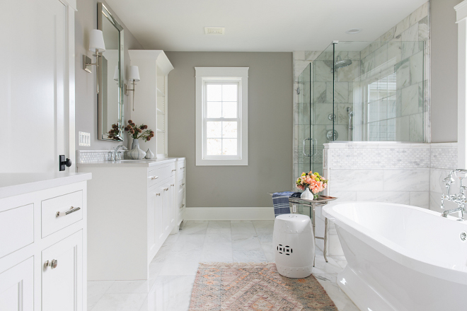 Grey bathroom with white cabinet and marble tile