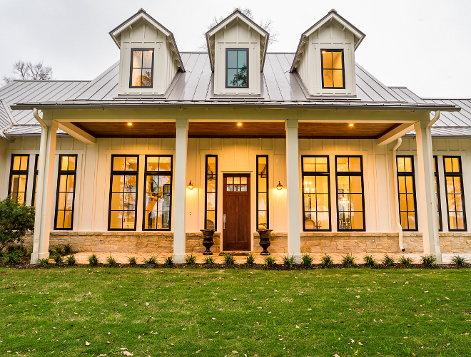 Modern Farmhouse Front Porch Metal Roof The front porch of this farmhouse features black windows, metal roof and a welcoming wooden front door Modern Farmhouse Front Porch Metal Roof #ModernFarmhouse #FrontPorch #MetalRoof