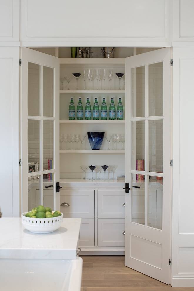 Pantry off kitchen with glass doors, open shelves, white marble countertop and lower cabinets with drawers Paint Color Benjamin Moore White Dove #Pantry #kitchenpantry #pantrydoors #PaintColor #BenjaminMooreWhiteDove
