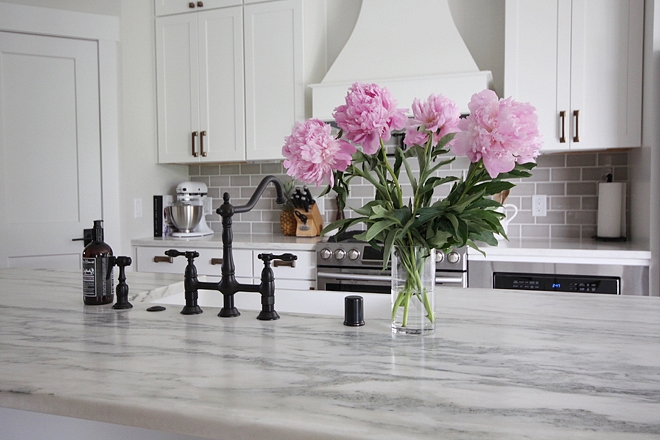 Countertop is Honed Carrara Marble White kitchen with honed Carrara marble countertop and pale grey subway tile Kitchen marble Honed Carrara Marble White kitchen with honed Carrara marble countertop and pale grey subway tile #HonedCarraraMarble #Whitekitchen #countertop #greysubwaytile