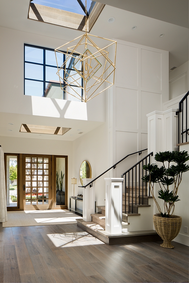 Farrow and Ball All White Foyer Two story foyer with skylight and grid board and batten wall Farrow and Ball All White Farrow and Ball All White #FarrowandBallAllWhite #foyer #gridboardandbatten #paintcolor