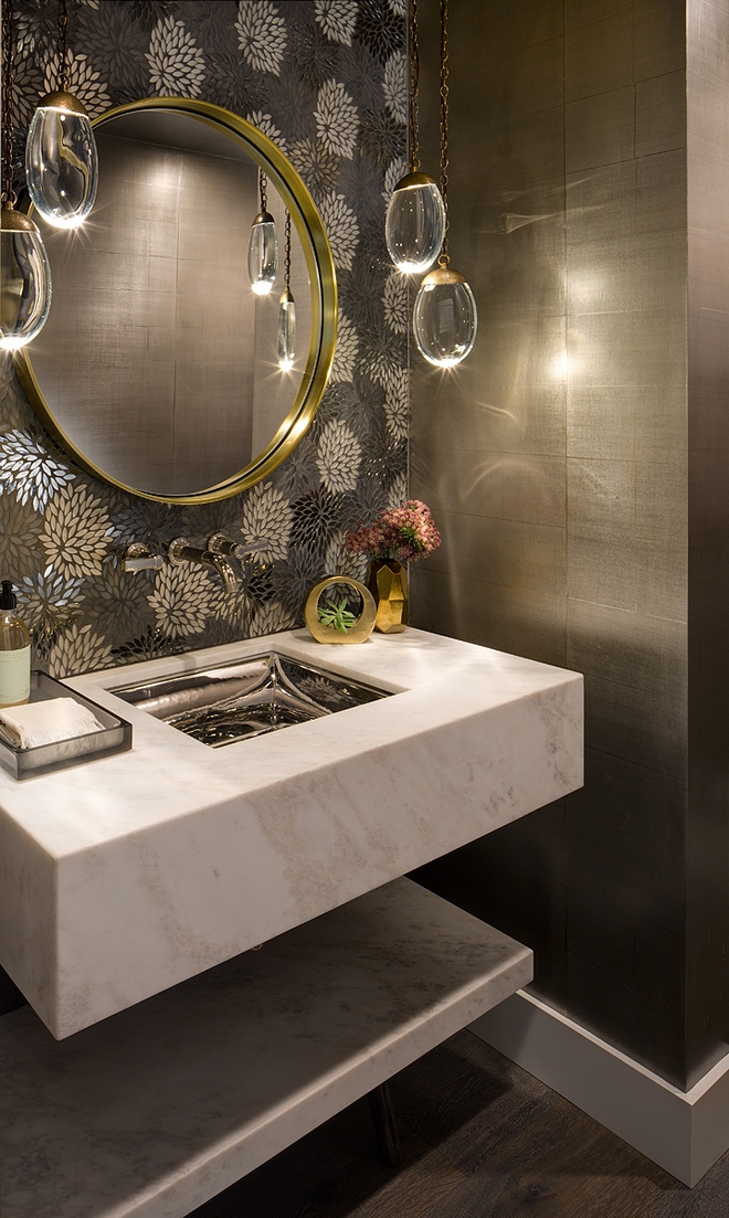 Floating Marble Vanity This powder room feels chic, tailored and impressive The floating vanity is custom honed Calacatta marble Accent tileabove vanity is Artistic Tile, Estrella Glass Silver tile Pendants are Ochre Celestial Pebble Pendants Floating Marble Vanity #FloatingMarbleVanity #FloatingVanity #marblevanity