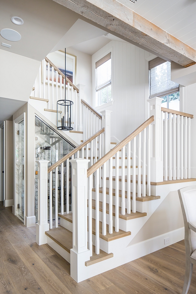 Staircase Millrwork The staircase features White Oak threads, White Oak handrail and vertical tongue and groove paneling #staircase #staircasethreads #WhiteOak #WhiteOakthreads #WhiteOakhandrail #handrail #verticaltongueandgroove #staircasepaneling