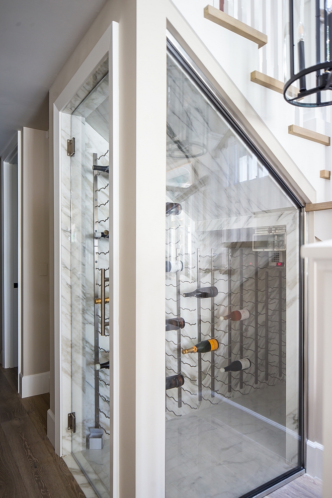 Under stair wine cellar The under stair wine cellar features stone slab walls, vintage-style wine racks and custom glass enclosure and door Understair wine cellar Understair wine cellar Understair wine cellar #Understairwinecellar #winecellar