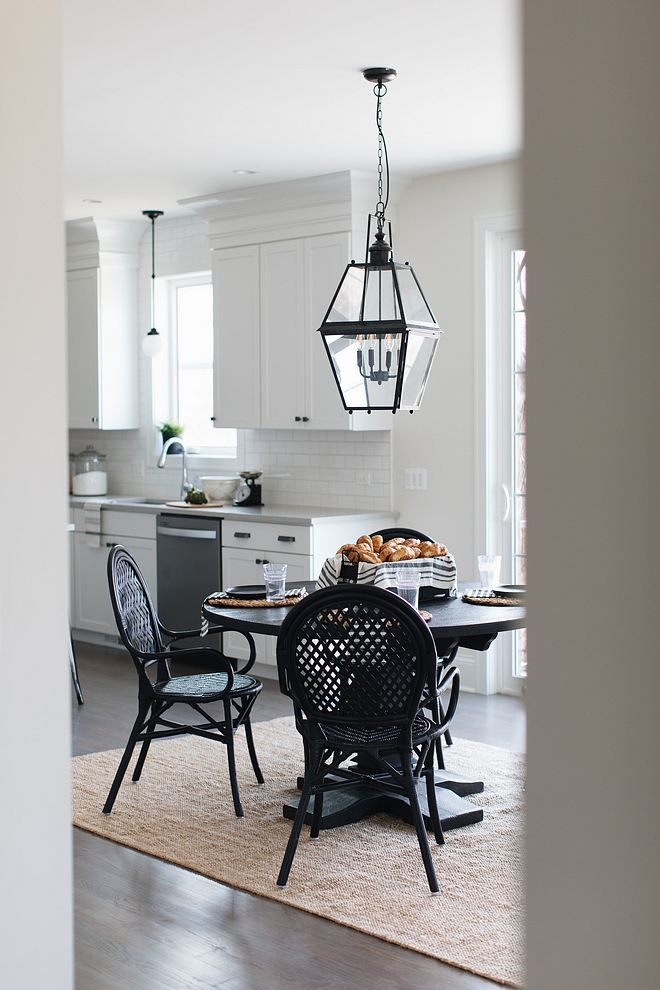 Farmhouse Breakfast Room Farmhouse Breakfast Room with jute rug large black lantern pendant light and black round dining table and black rattan dining chairs from Ikea Farmhouse Breakfast Room Farmhouse Breakfast Room #FarmhouseBreakfastRoom #Farmhouse #BreakfastRoom #lighting #juterug #rounddiningtable #ikeachairs