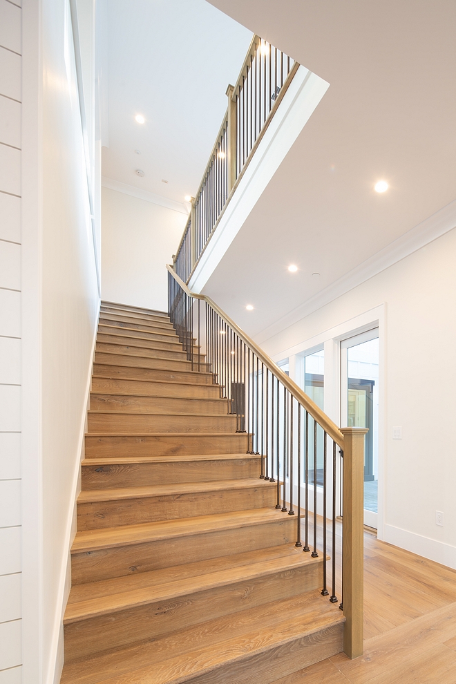 White Oak Staircase The staircase features White Oak threads, custom stained to match the hardwood flooring, metal spindles and White Oak railing and baluster #whiteoak #staircase #whiteoakstaircase #whiteOakthreads #staircasethreads #hardwoodflooring #metalspindles#WhiteOakrailing #railing #baluster