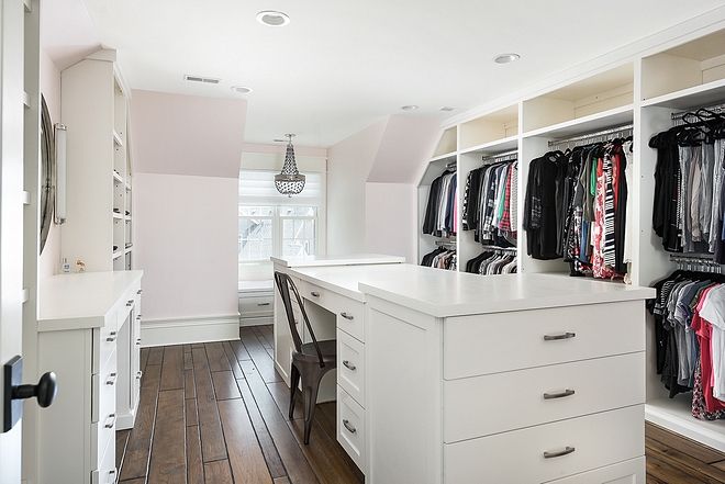 Walk in closet with long island with desk
