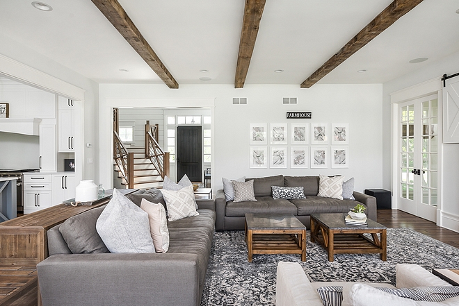 Farmhouse living room with beams and white walls painted in White Dove by Benjamin Moore Decor sources on Home Bunch