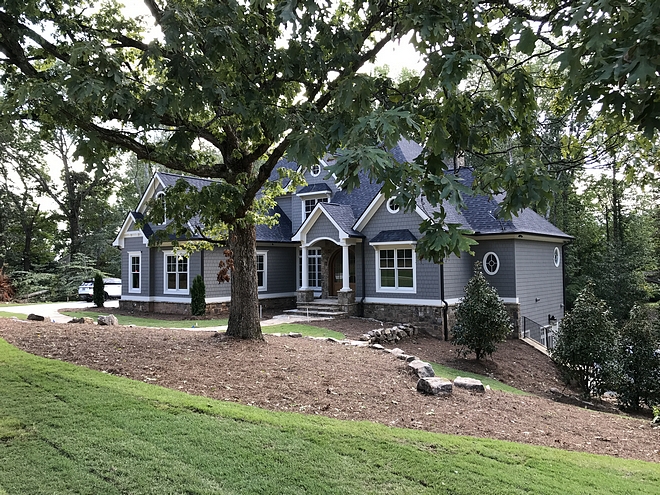 This newly-built home features gorgeous roof lines, transoms and round windows #home #newlybuilthome #curbappeal