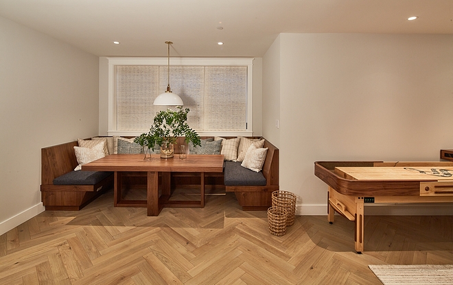 Basement Nook The nook features herringbone flooring, an u-shaped built-in banquette and a custom dining table Basement Nook #Basement #Nook