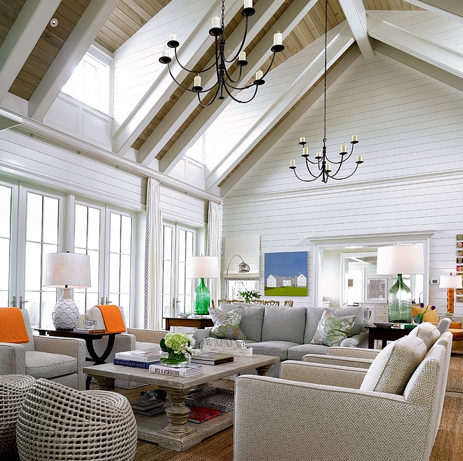 High Ceiling Living room with vaulted ceiling clad in White Oak Shiplap Walls are clad in white shiplap #HighCeiling #Livingroom #vaultedceiling #WhiteOakShiplap #shiplap