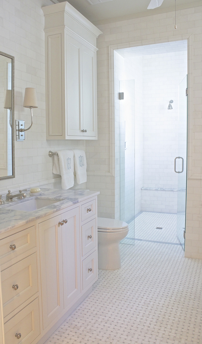 This bathroom features a classic combination of white subway tile on walls and marble basketweave floor tile Notice the curb-bless shower #bathroom #classicbathroom #curblessshower