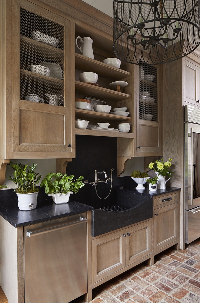 Butlers Pantry The butler's pantry features Rift Oak cabinet, Soapstone countertop, Soapstone slab backsplash and a custom natural stone farmhouse sink, also made of Soapstone Flooring is reclaimed brick Brick laid in a basket weave pattern #butlerspantry #RiftOakcabinet #Soapstone #countertop #slabbacksplash #stonefarmhousesink #brickFlooring #reclaimedbrick