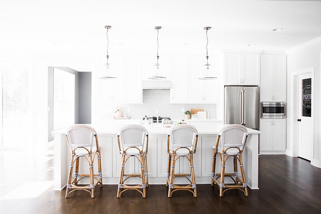 This kitchen looks too bright/stark here due the photography adjustments, but this kitchen is, in fact, well-balanced with the white cabinets, grey backsplash tile and dark hardwood flooring