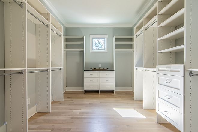 Walk-in closet features White Oak hardwood floors and custom-fit closet system Closet custom-fit closet system #closetsystem #closet #walkincloset