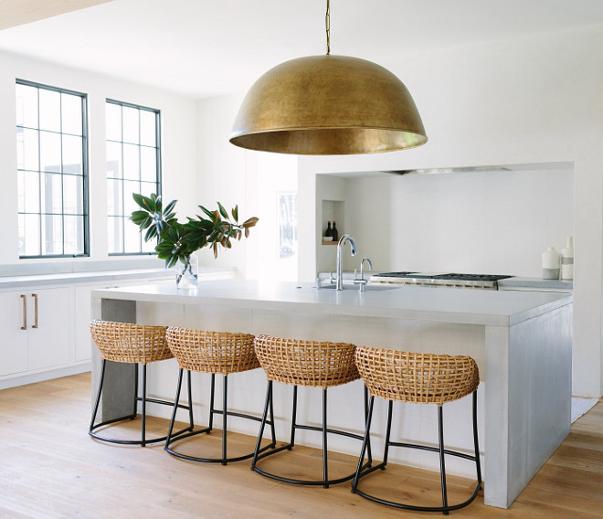 Clean-lined Kitchen painted in Benjamin Moore White Dove and with Concrete waterfall island countertop #CleanlinedKitchen #kitchen #BenjaminMooreWhiteDove #Concretecountertop #waterfallisland #countertop