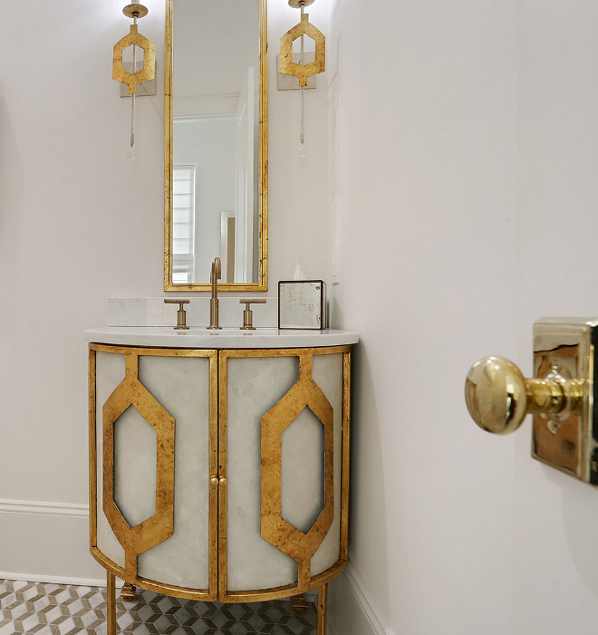 Powder room vanity Powder room features a stunning custom vanity cabinet, mirror and sconces. They are fabricated and painted in a cream whitewash finish with gold trim #Powderroom #Powderroomvanity