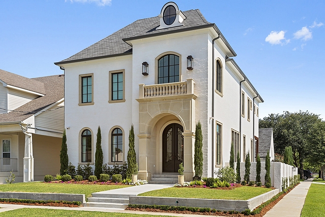 Exterior is brick with white mortar - sacking rub covering brick and Cast stone trim on windows and trimming front entrance #exterior #brick