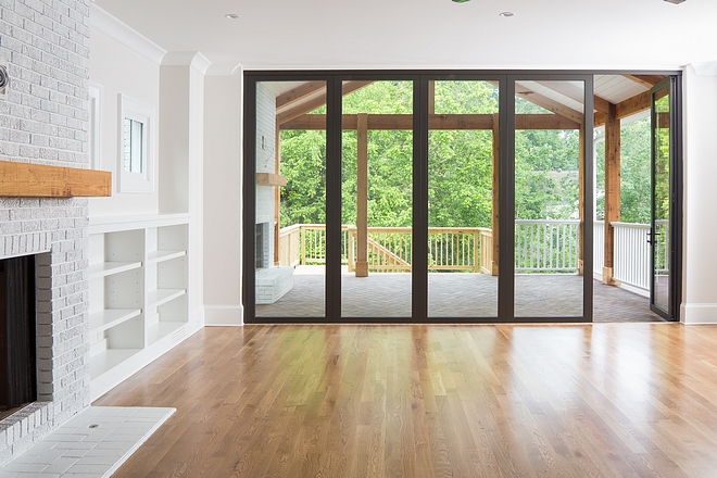 The builder extended the living area with a floor to ceiling, fully retractable panoramic door opening to the covered deck and outdoor living space