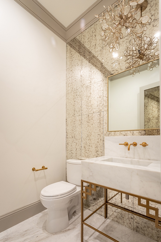 Powder room Glamorous Powder room with Antique Mirror Tile wall tile, brass and marble washstand and brass mirror sources on Home Bunch #Powderoom #AntiqueMirrorTile #MirrorTile